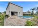 Inviting pool area with a patio, lounge chair, grill, and outdoor dining set at 7524 Marker Ave, Kissimmee, FL 34747