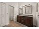 Bathroom with double vanity, framed mirrors, tile floor, and a doorway to the enclosed toilet at 7528 Chapelhill Dr, Orlando, FL 32819