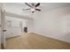 Bright bedroom featuring wood floors, ceiling fan and an en suite bathroom with a vanity at 7528 Chapelhill Dr, Orlando, FL 32819