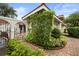 An enclosed courtyard with a garden bed filled with greenery and a brick path at 7528 Chapelhill Dr, Orlando, FL 32819