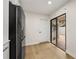 Bright kitchen with a stainless steel refrigerator and sliding door to the brick courtyard at 7528 Chapelhill Dr, Orlando, FL 32819