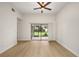 A sunlit living room with hardwood floors and large sliding doors that lead to outdoor space at 7528 Chapelhill Dr, Orlando, FL 32819