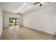 Bright and airy living room featuring hardwood floors and sliding glass doors leading to the outdoors at 7528 Chapelhill Dr, Orlando, FL 32819