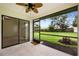A covered outdoor patio offers a view of the green lawn at 7528 Chapelhill Dr, Orlando, FL 32819