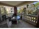 Charming outdoor balcony area for relaxing with view of building, trees and tropical landscaping at 7651 Whisper Way # 201, Kissimmee, FL 34747
