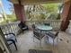 Comfortable balcony with an outdoor table and chairs, ideal for relaxation and enjoying the scenery at 7651 Whisper Way # 201, Kissimmee, FL 34747