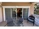 Outdoor balcony with a seating area, offering a glimpse into the home's interior at 7651 Whisper Way # 201, Kissimmee, FL 34747