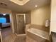 The bathroom boasts a large soaking tub and glass shower at 7651 Whisper Way # 201, Kissimmee, FL 34747