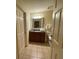 Bathroom featuring dark wood vanity with mirror, tile flooring, and toilet at 7651 Whisper Way # 201, Kissimmee, FL 34747