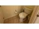Clean bathroom featuring neutral tile flooring and a standard toilet with fresh sanitary seal at 7651 Whisper Way # 201, Kissimmee, FL 34747