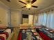 Comfortable bedroom features three beds, a ceiling fan, and ample closet space at 7651 Whisper Way # 201, Kissimmee, FL 34747