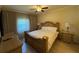 A spacious bedroom with a ceiling fan, dresser, and plenty of natural light at 7651 Whisper Way # 201, Kissimmee, FL 34747