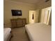 Bright bedroom showcasing a dresser, ceiling fan, and access to an adjacent room at 7651 Whisper Way # 201, Kissimmee, FL 34747