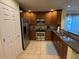 Well-equipped kitchen with stainless steel appliances, wood cabinets and tile floors for a modern touch at 7651 Whisper Way # 201, Kissimmee, FL 34747