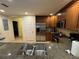Updated kitchen with stainless steel appliances, granite countertops, and wood cabinets at 7651 Whisper Way # 201, Kissimmee, FL 34747