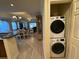 Hall view of the home showcases in-unit laundry and open access to kitchen and dining at 7651 Whisper Way # 201, Kissimmee, FL 34747