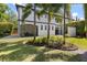 The backyard boasts lush landscaping and a screened-in patio, perfect for outdoor relaxation at 8113 Via Vittoria Way, Orlando, FL 32819