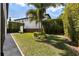 A spacious backyard surrounded by a lush privacy hedge and meticulously maintained landscaping at 8113 Via Vittoria Way, Orlando, FL 32819