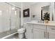 Bathroom featuring white cabinets, quartz countertop, enclosed glass shower, and modern fixtures at 8113 Via Vittoria Way, Orlando, FL 32819