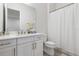 Traditional bathroom with a single sink vanity, white cabinets, and a shower with a curtain at 8113 Via Vittoria Way, Orlando, FL 32819