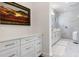 Bright bathroom featuring double vanity, framed artwork and a luxurious glass enclosed shower at 8113 Via Vittoria Way, Orlando, FL 32819