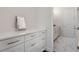 Bright bathroom featuring a vanity with white cabinets, quartz counters and a Hollywood-style mirror at 8113 Via Vittoria Way, Orlando, FL 32819