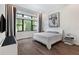 Serene bedroom with natural light, wood floors, and modern decor at 8113 Via Vittoria Way, Orlando, FL 32819