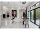 Elegant dining area with unique lighting, marble floors, and a large painting, adjacent to the kitchen at 8113 Via Vittoria Way, Orlando, FL 32819