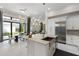 Spacious kitchen with island seating, open to the dining and living areas and featuring stainless steel appliances at 8113 Via Vittoria Way, Orlando, FL 32819