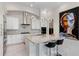 Beautiful open kitchen with modern appliances, a center island, and white cabinets beneath elegant pendant lighting at 8113 Via Vittoria Way, Orlando, FL 32819