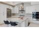 Modern white kitchen with stainless steel appliances and a gray granite island at 8113 Via Vittoria Way, Orlando, FL 32819