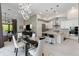 Bright and open kitchen and living area with pendant lighting, marble tile floors, and stainless appliances at 8113 Via Vittoria Way, Orlando, FL 32819