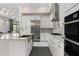 Bright, well-equipped kitchen with stainless appliances, white cabinets and a central island with sink at 8113 Via Vittoria Way, Orlando, FL 32819