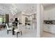 Bright and open kitchen and living area with pendant lighting, marble tile floors, and stainless appliances at 8113 Via Vittoria Way, Orlando, FL 32819