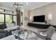 Comfortable living area with a large TV, textured wall, and modern furnishings at 8113 Via Vittoria Way, Orlando, FL 32819