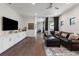 Living space with hardwood floors, an entertainment center, and a comfy leather couch at 8113 Via Vittoria Way, Orlando, FL 32819