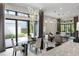 Bright, open-concept living and dining area with modern lighting and seamless indoor-outdoor flow to a landscaped yard at 8113 Via Vittoria Way, Orlando, FL 32819