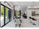 Bright and open-concept living space with sliding doors, unique lighting fixtures, and an elegant modern design at 8113 Via Vittoria Way, Orlando, FL 32819
