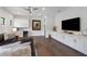 Entertaining room with hardwood floors, recessed lights, a wet bar, and a large flat screen tv at 8113 Via Vittoria Way, Orlando, FL 32819