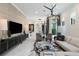 Bright open-concept living space with large TV, modern lighting, and comfortable seating at 8113 Via Vittoria Way, Orlando, FL 32819