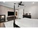 Stylish main bedroom with decorative accent wall, ceiling fan and white plush rug at 8113 Via Vittoria Way, Orlando, FL 32819