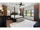 Spacious main bedroom featuring a four-poster bed, plush rug, and dark wood accents at 8113 Via Vittoria Way, Orlando, FL 32819