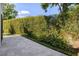 A private outdoor stone patio is surrounded by tall hedges providing a serene retreat at 8113 Via Vittoria Way, Orlando, FL 32819