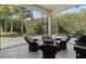 The covered and screened-in patio has comfortable seating and a beautiful view of the landscaped backyard at 8113 Via Vittoria Way, Orlando, FL 32819