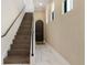 Entry way with hardwood stairs, white risers, and a charming dark-stained front door at 8113 Via Vittoria Way, Orlando, FL 32819