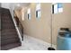 Open staircase with a stylish, modern railing, bright windows, elegant decorations, and marble tile floors at 8113 Via Vittoria Way, Orlando, FL 32819