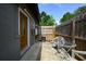 Private back patio with a table and chairs, enclosed by a wooden fence at 874 Brevard Ct, Orlando, FL 32822