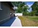 Fenced backyard with a concrete walkway, a window bar, and views of lush greenery at 874 Brevard Ct, Orlando, FL 32822