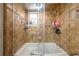 Bathroom featuring textured tile, neutral paint, shower, tub, and storage at 874 Brevard Ct, Orlando, FL 32822