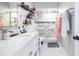 Bathroom featuring marble tile, neutral paint, shower, toilet, and sink area at 874 Brevard Ct, Orlando, FL 32822